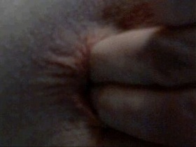 man thumbs and blinks rectum up close on webcam